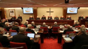 Imagen de la 129ª Asamblea Plenaria CEE en Madrid con el logo de ECO NOTICIA en las pantallas, mostrando a los obispos españoles en reunión.